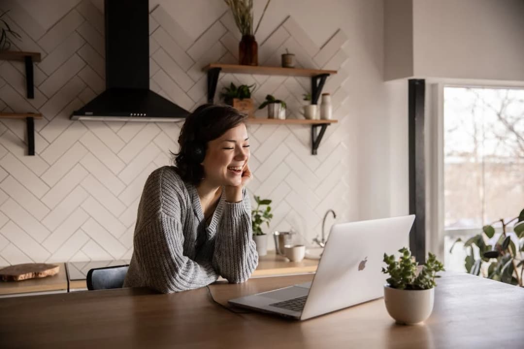 A woman is talking to a person on a laptop in a long distance relationship